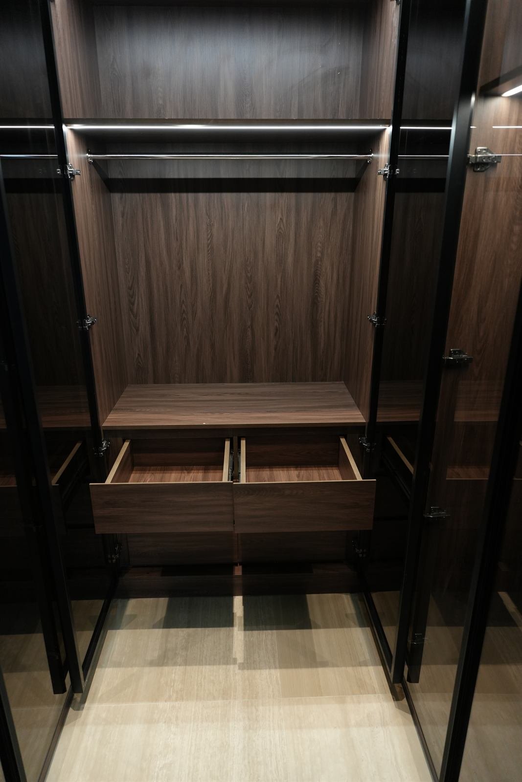 Luxury dressing room cabinetry with glass shelving