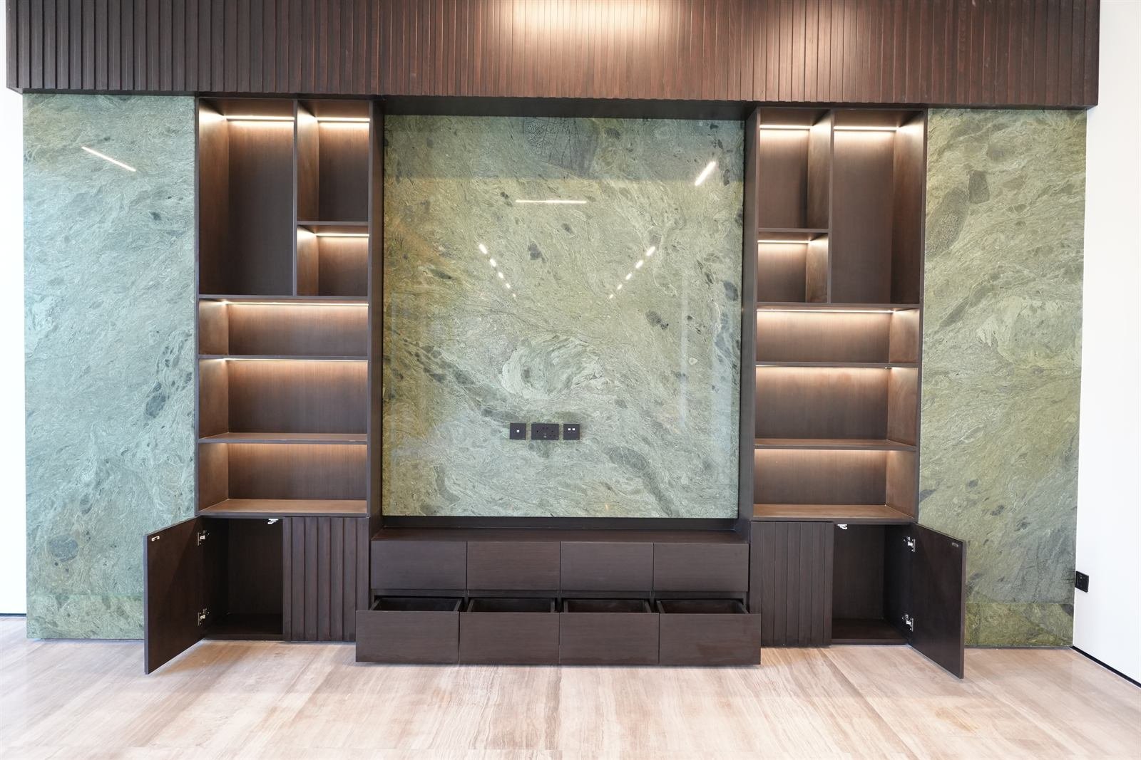 Custom TV unit with storage drawers and stone backdrop